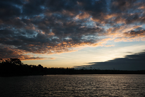 Tranquil landscape of lake inside tropical rainforest at sunrise.