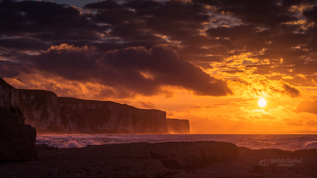 Dramatic cloudy sunset above the cliffs