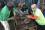 Workers remove the melted mixed plastic, which is then moved into presser forms to solidify into the desired shape.